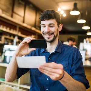 Man taking photo of check for mobile deposit