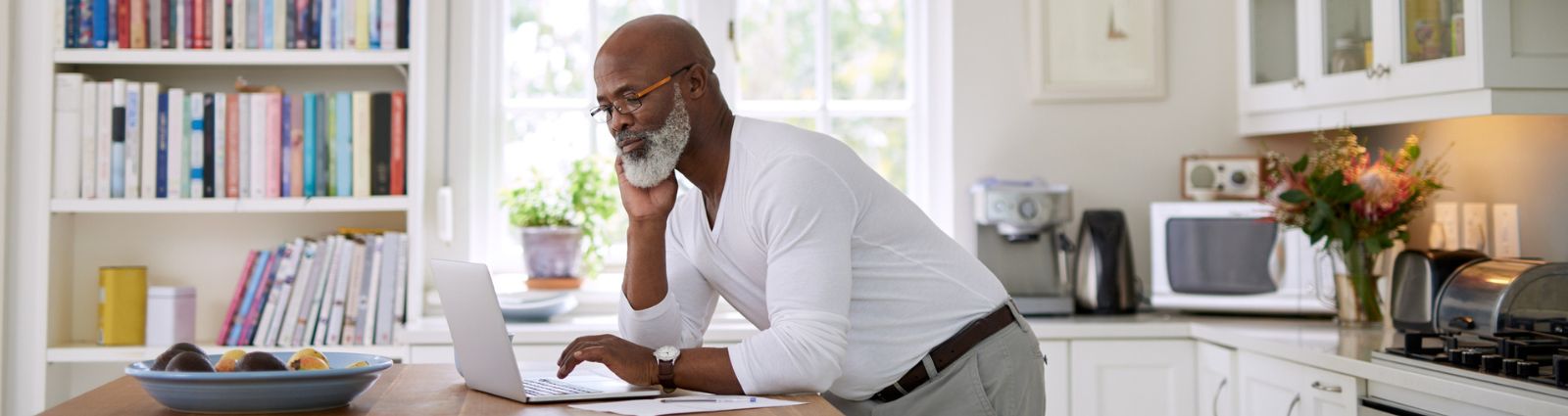 Man looking at laptop in home