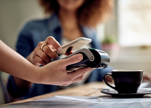 Woman pays with phone in cafe