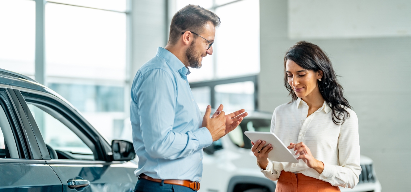 Couple in car dealership